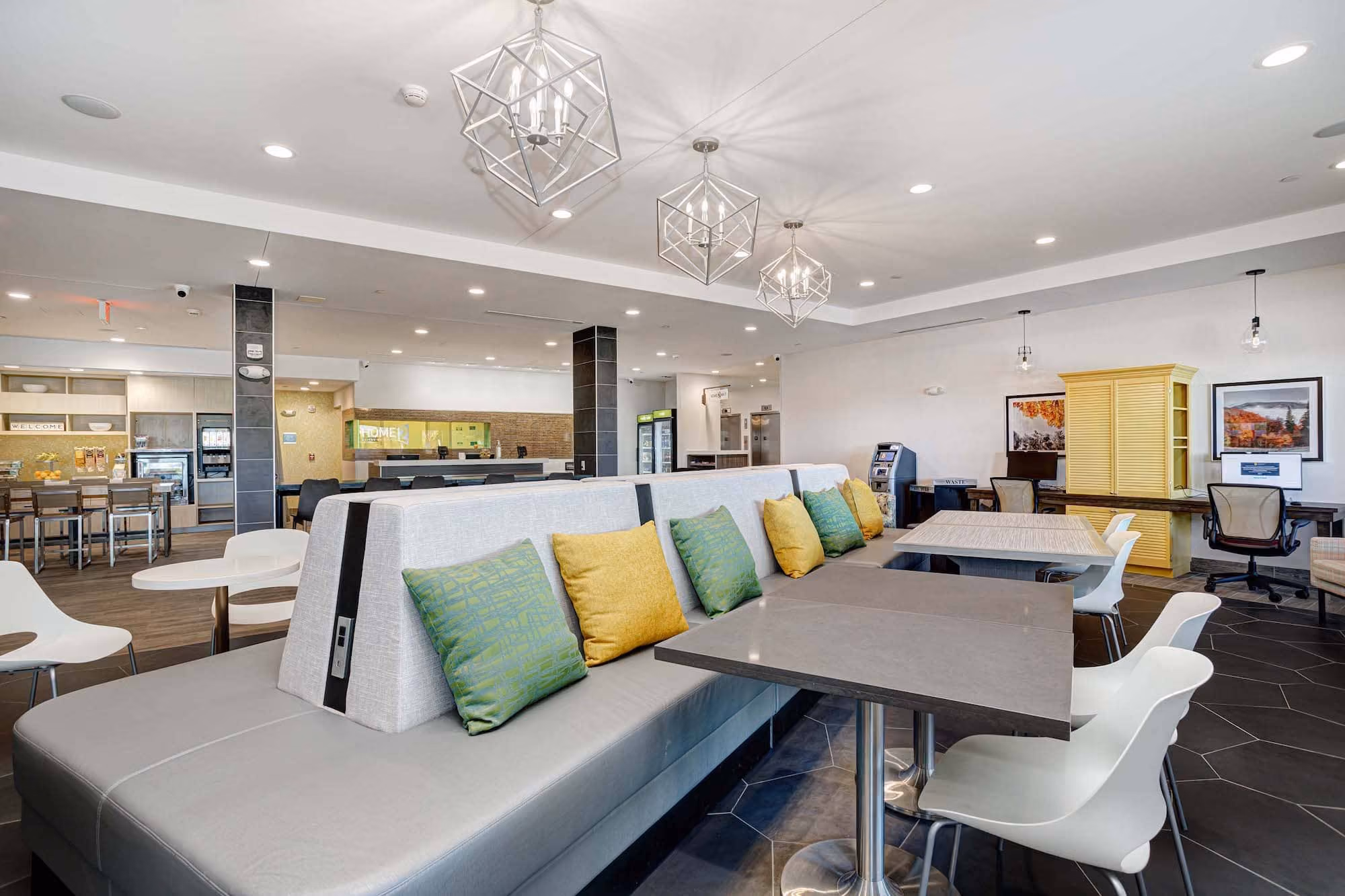 Modern hotel lobby seating area with tables and pendant lights, designed by D&S Builders