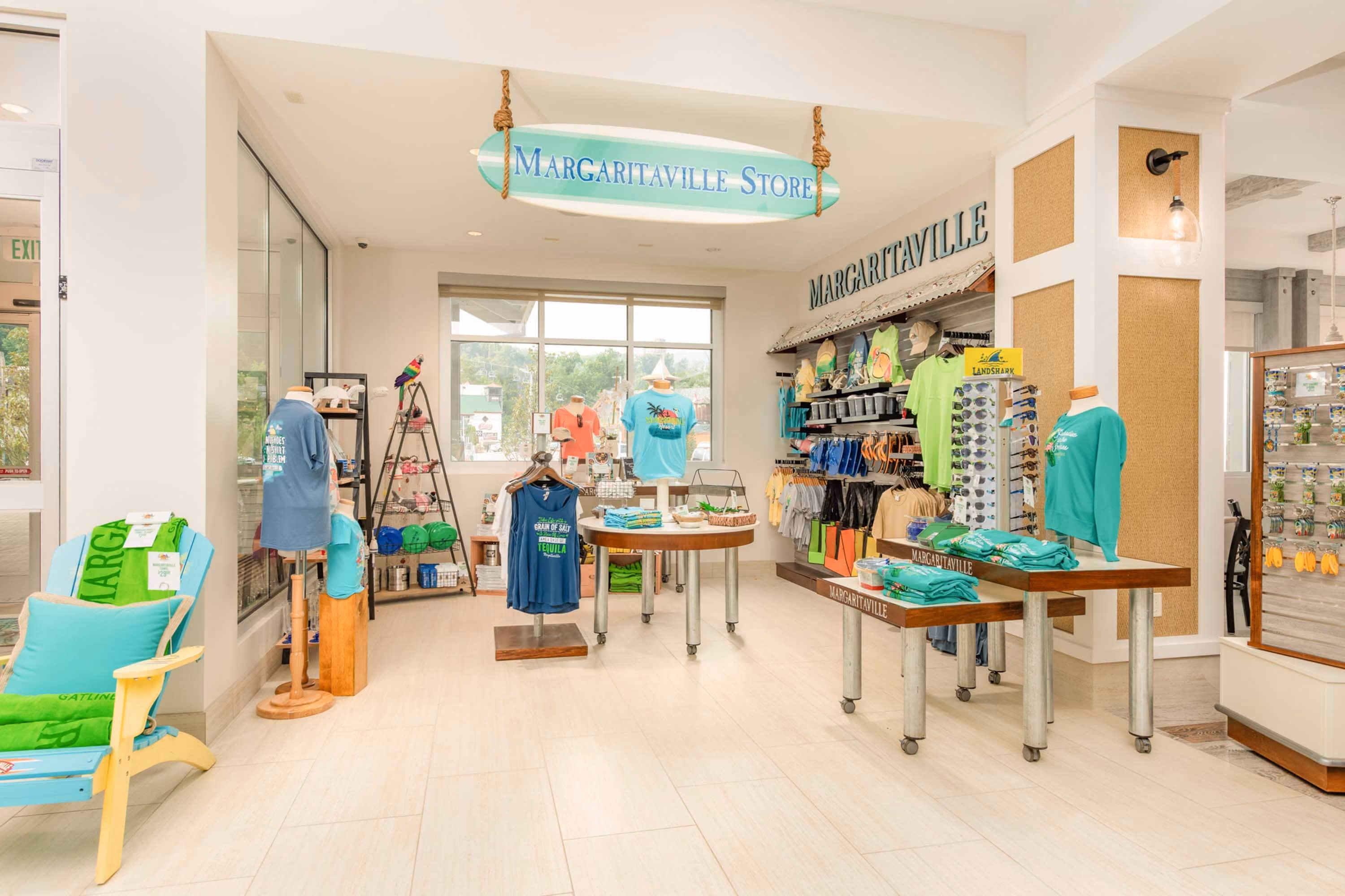 Bright retail store interior with Margaritaville merchandise displays and hanging sign