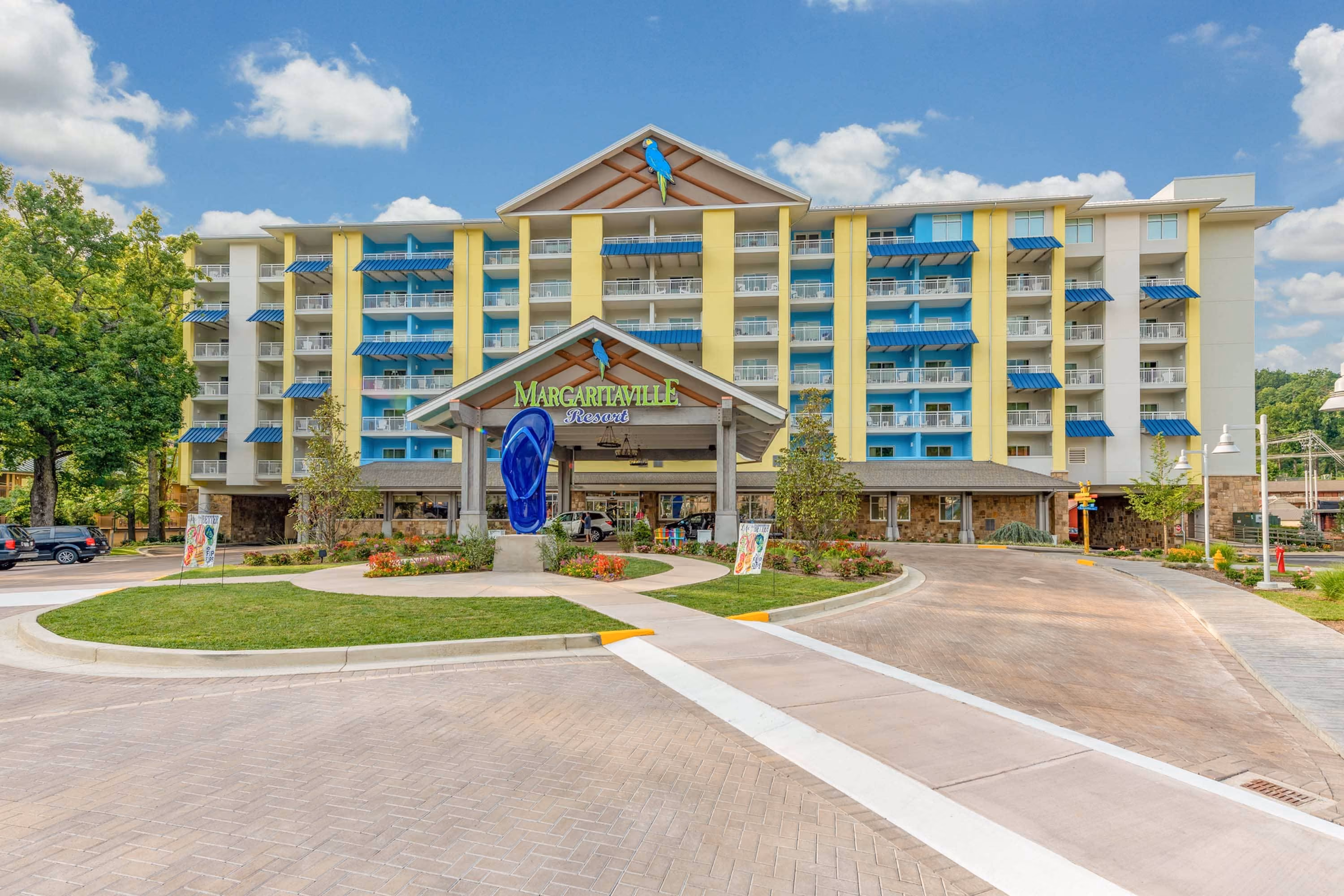 Margaritaville Resort hotel entrance with blue awnings and landscaped driveway