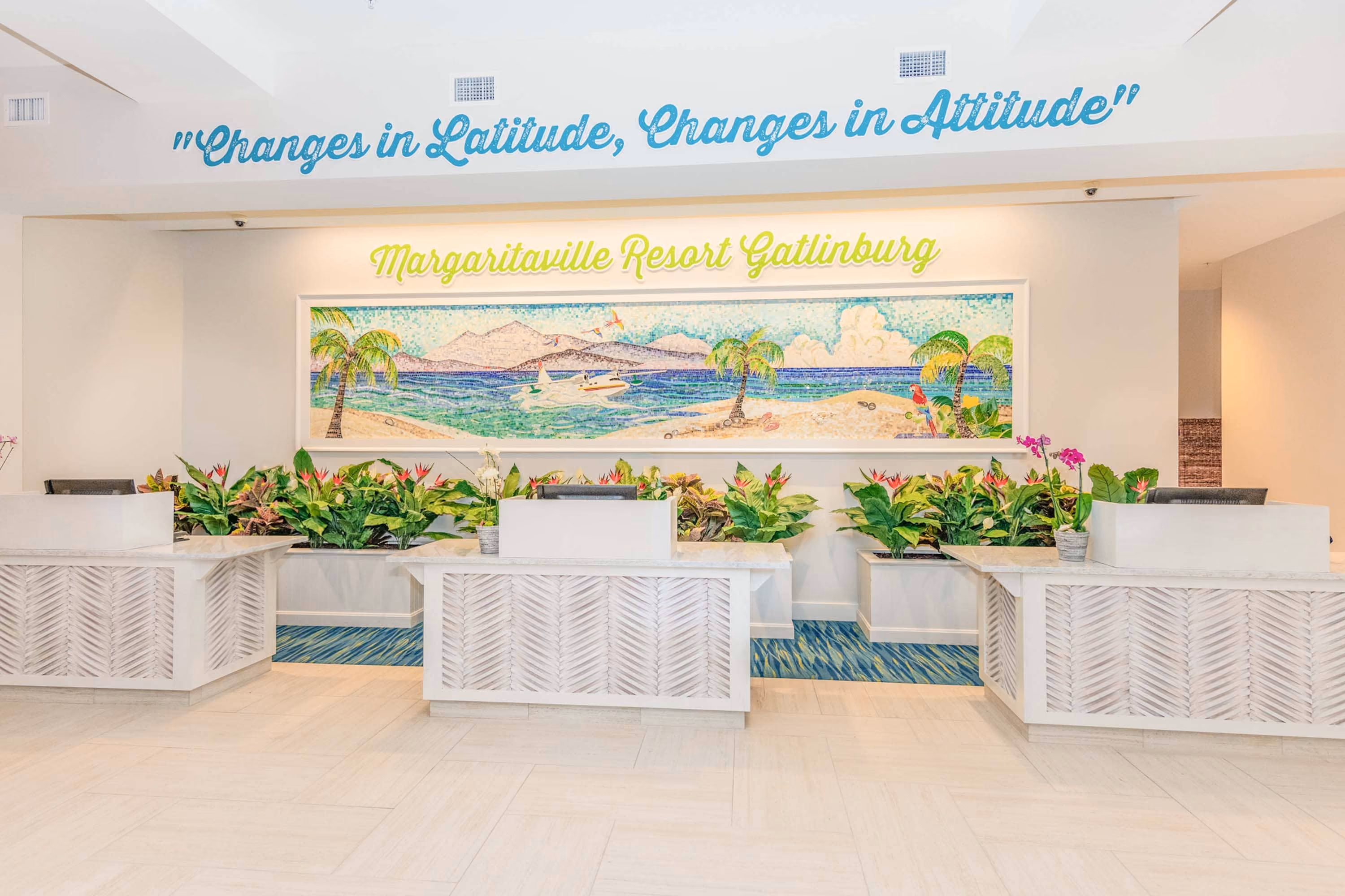 Margaritaville Resort Gatlinburg lobby reception desks with tropical mural and plants