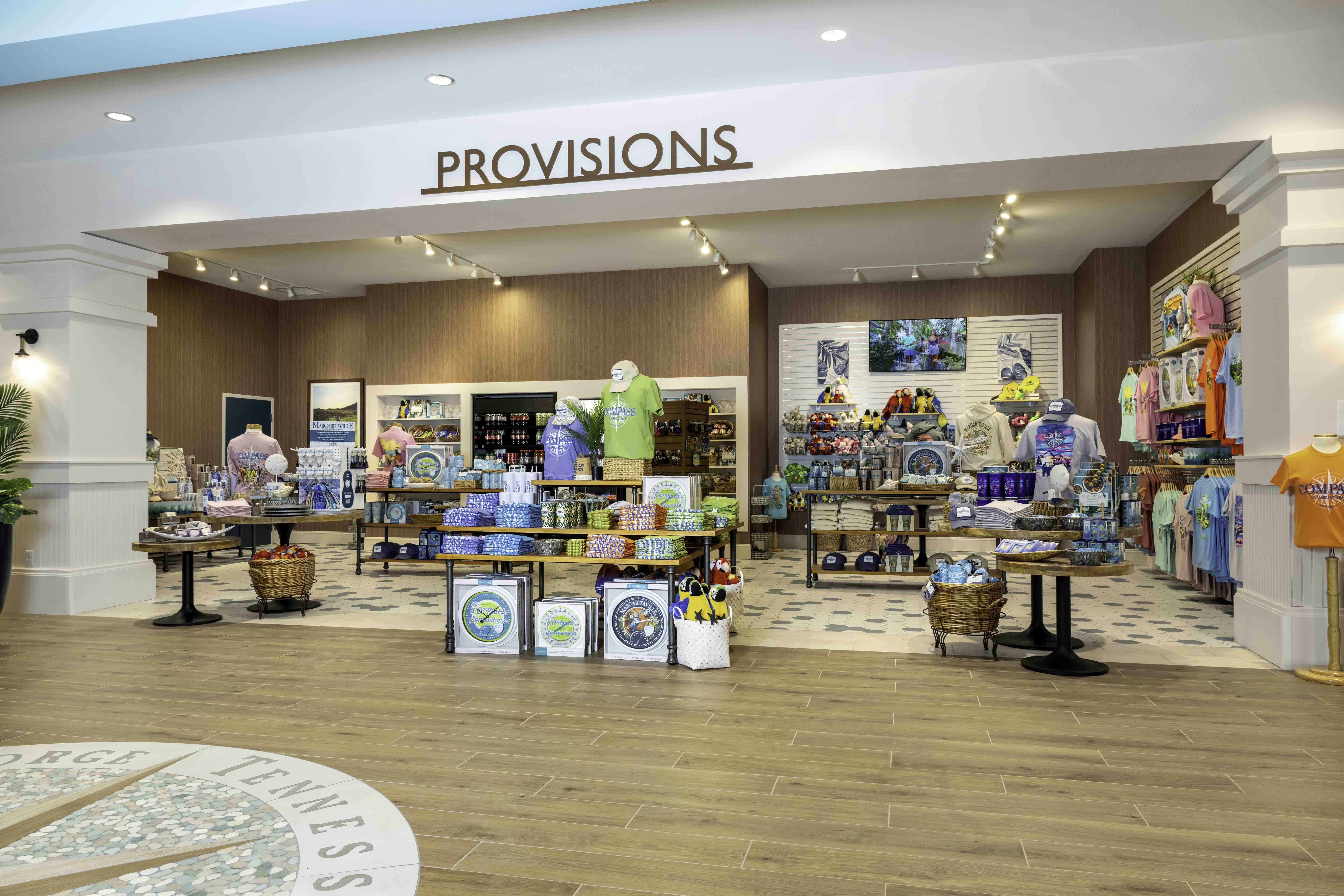 Retail shop display with souvenirs, apparel, and gifts under a Provisions sign
