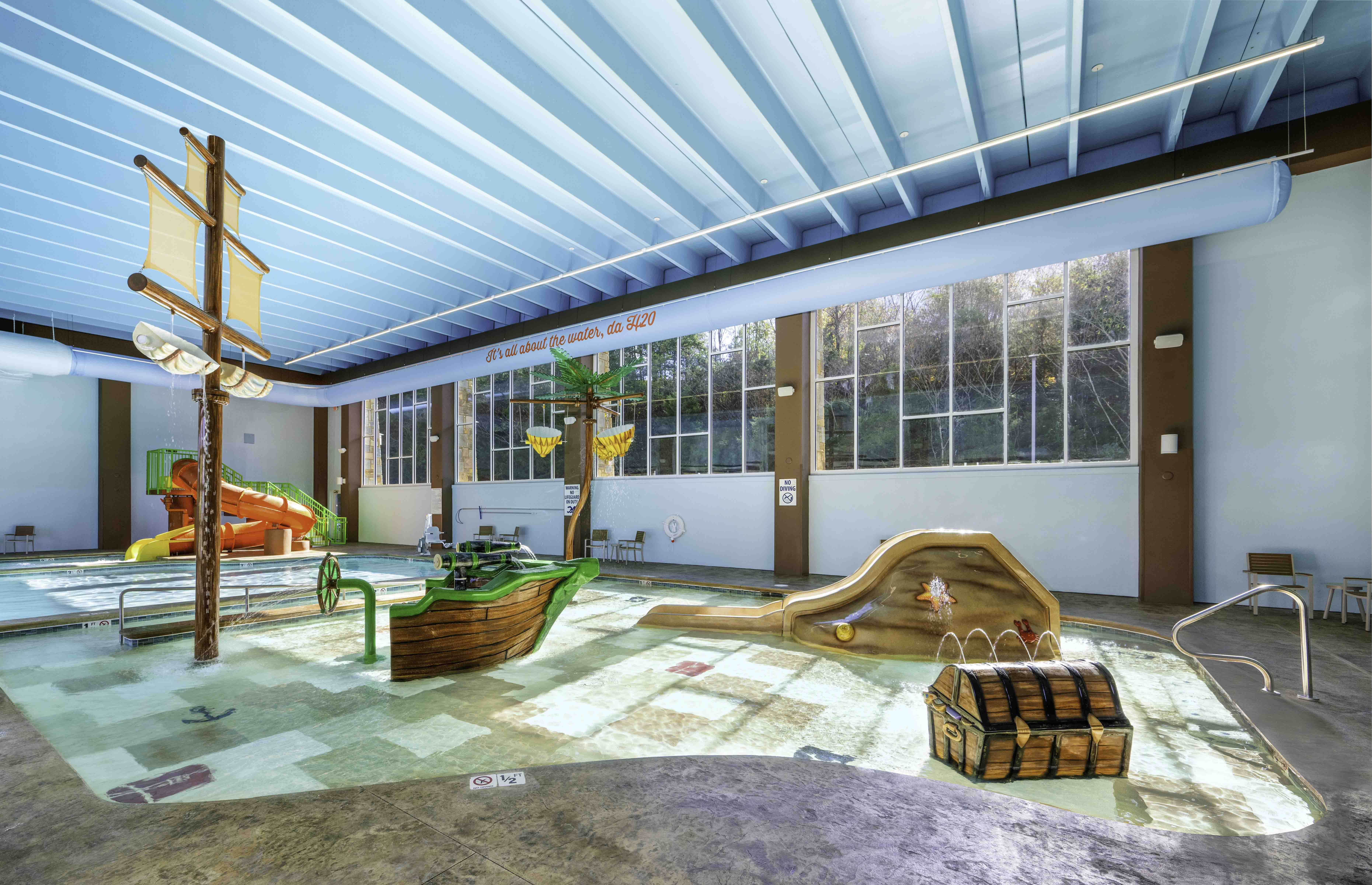 Indoor pirate-themed pool with slides and play features at a hospitality construction project by D&S Builders