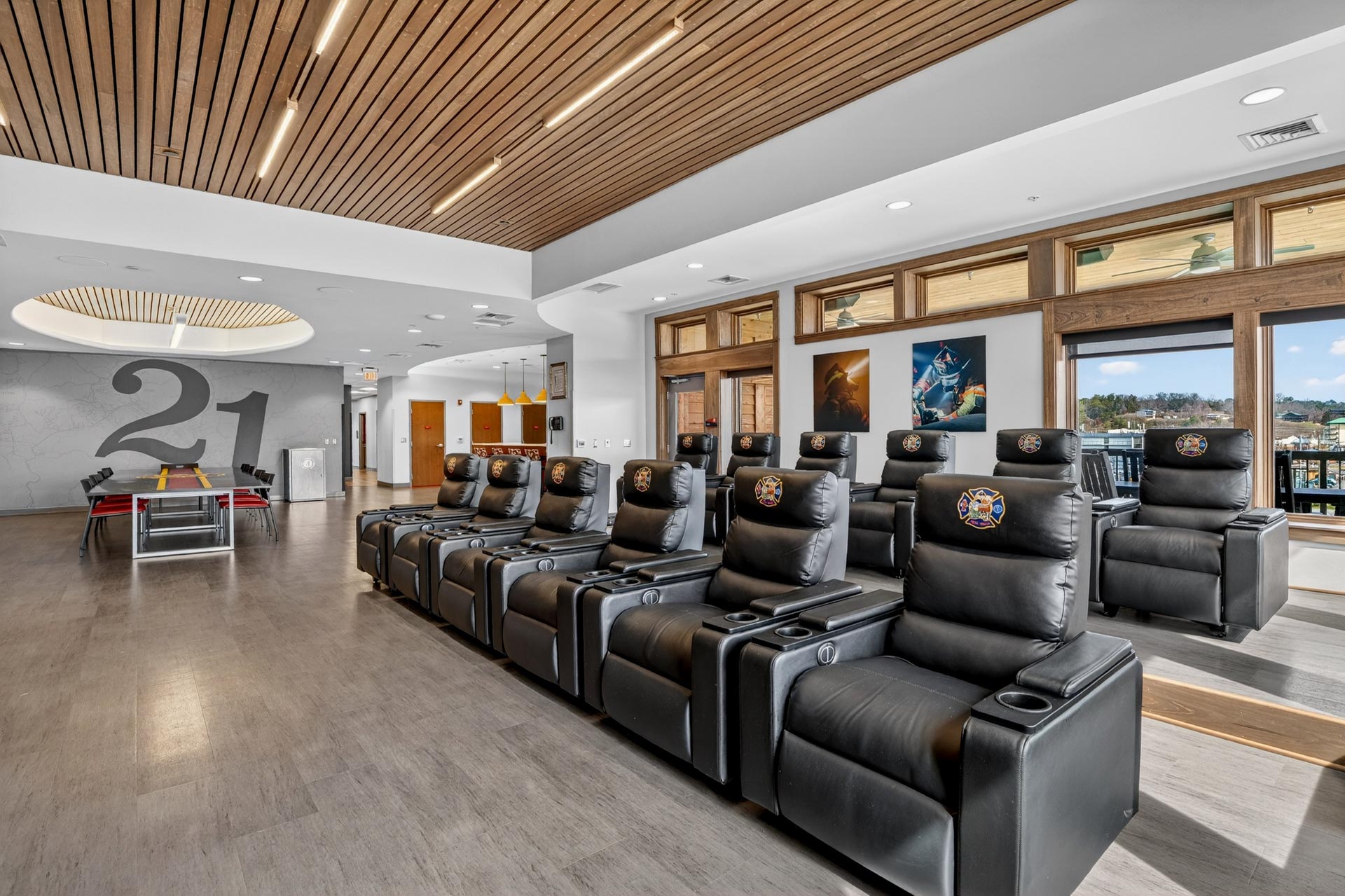 Modern hospitality lounge with black recliners and wood-slat ceiling, D&S Builders construction