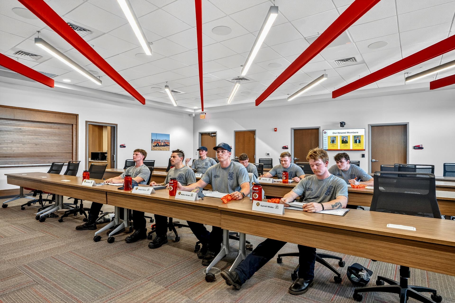 Training room with workers seated at tables in a D&S Builders hospitality construction meeting