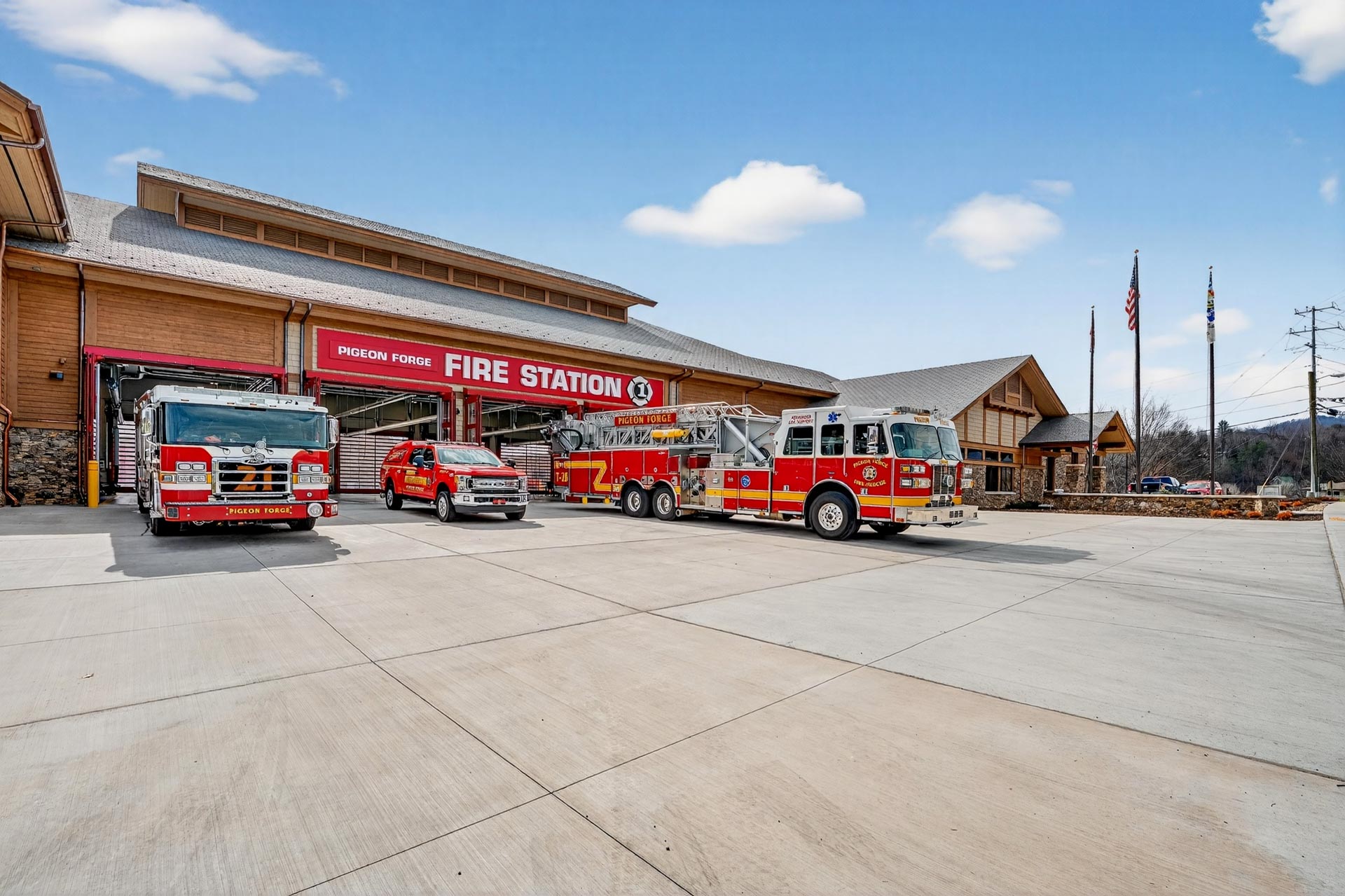 Pigeon Forge fire station with fire trucks parked outside under a blue sky