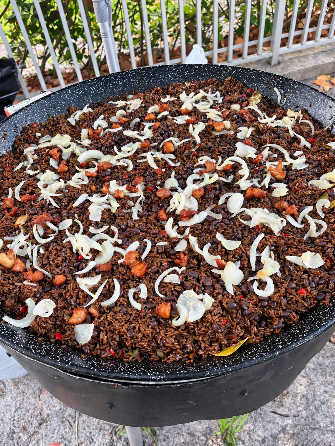 Close view of Don Paella Arroz Moro, Cuban rice and black beans topped with onions and pork pieces