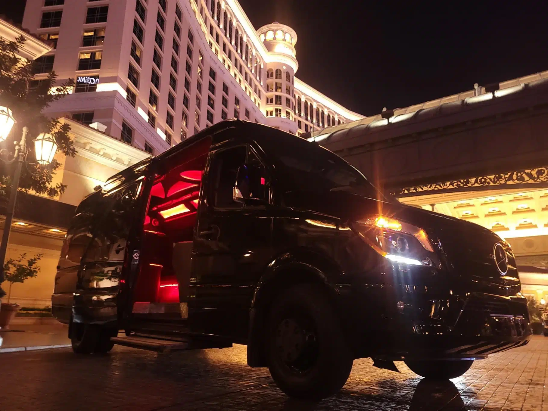 A chartered Mercedes van outside a Las Vegas hotel at night