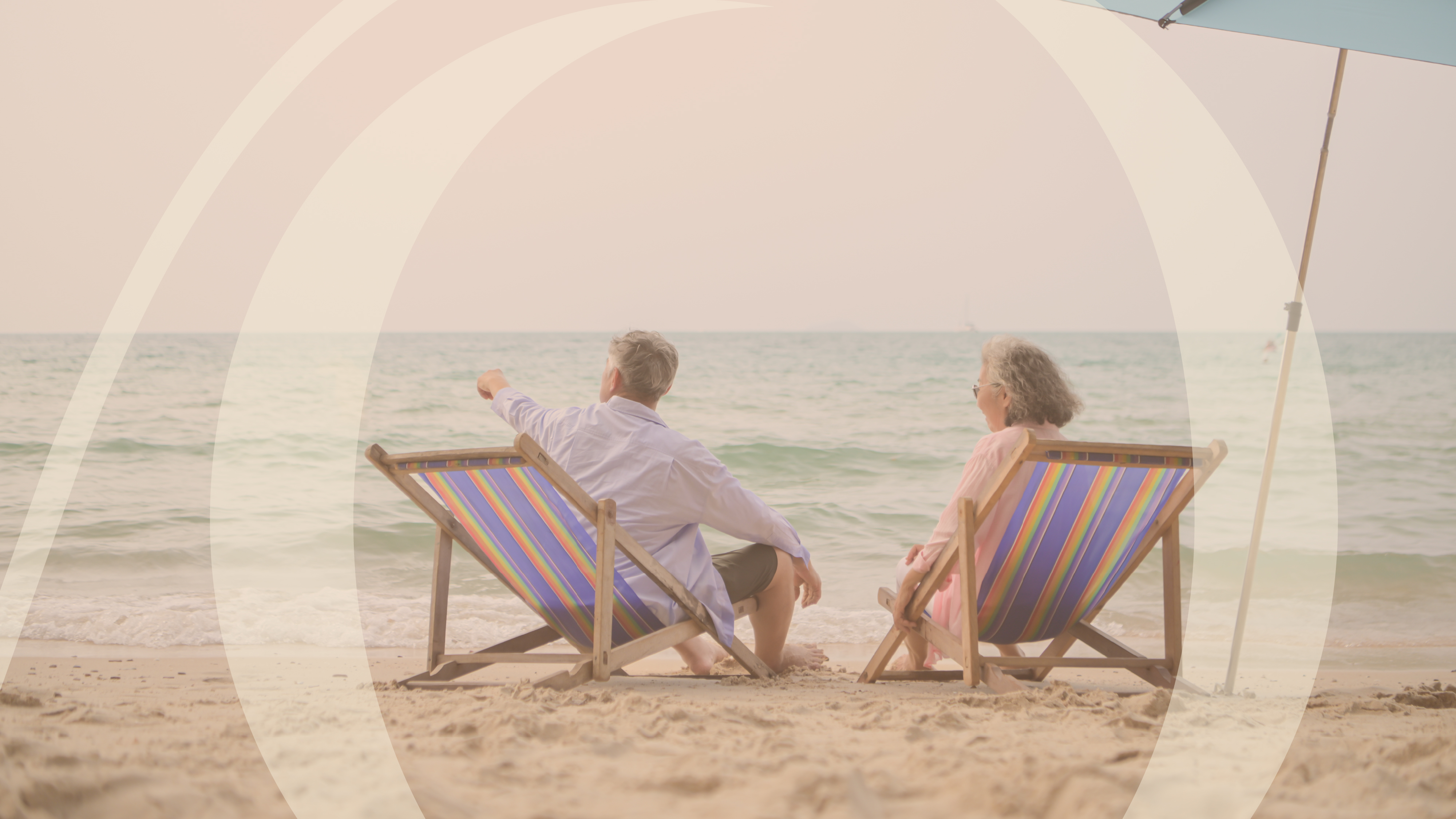 Older couple relaxing in beach chairs by the ocean