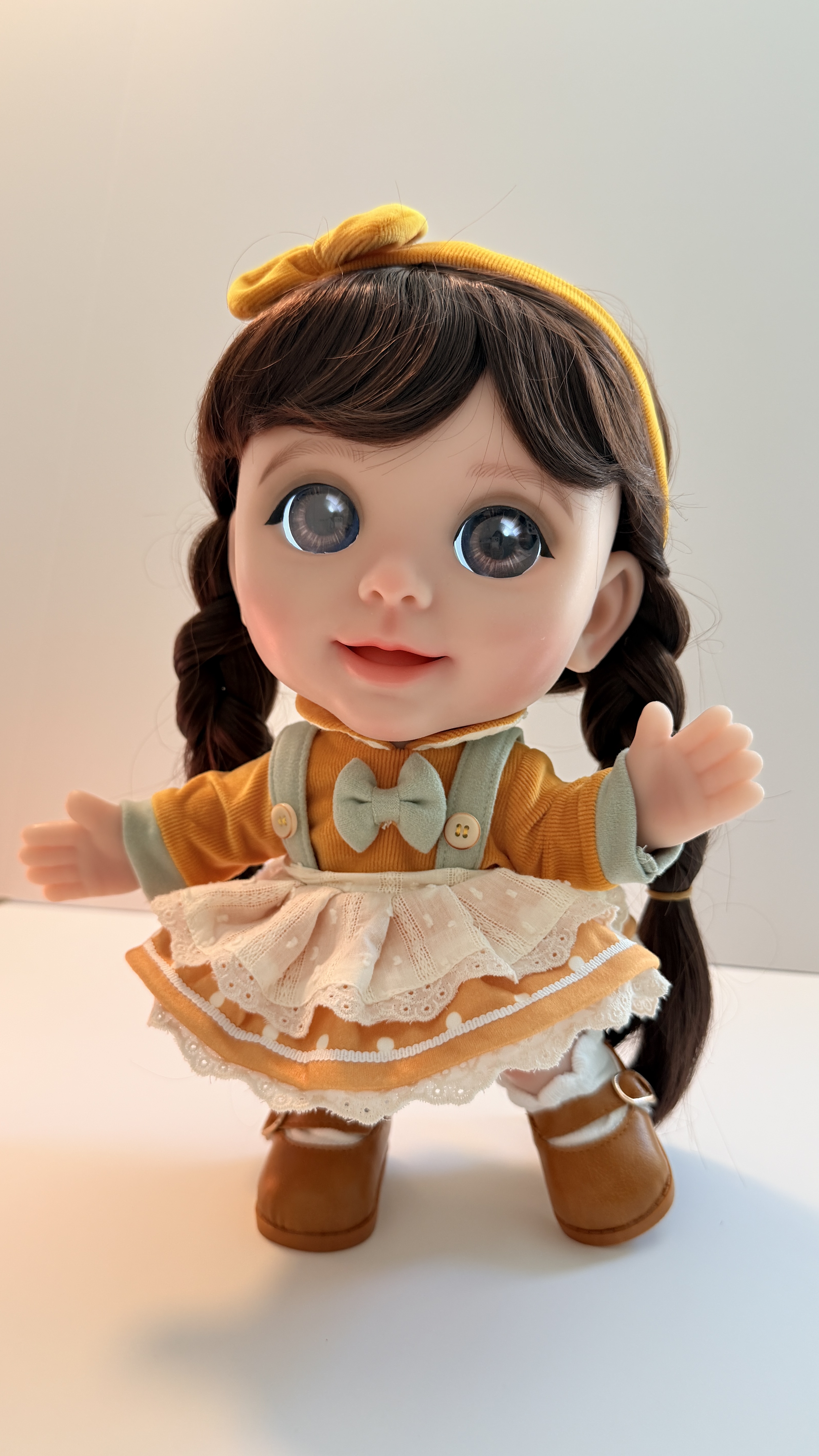 Joy with long dark braids in the marigold pinafore and lace apron
