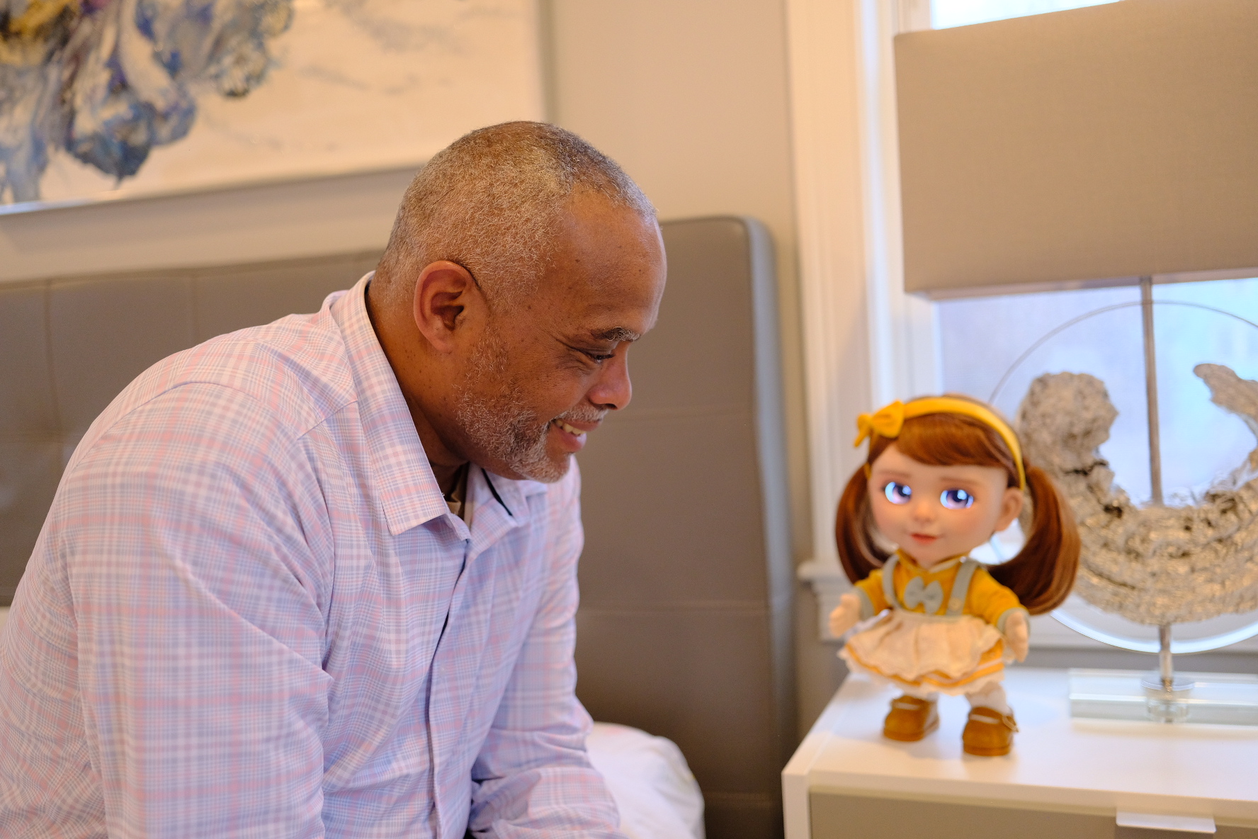 An older man chatting with Joy at his bedside