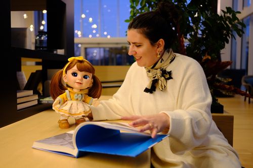 A woman reading a book together with Joy