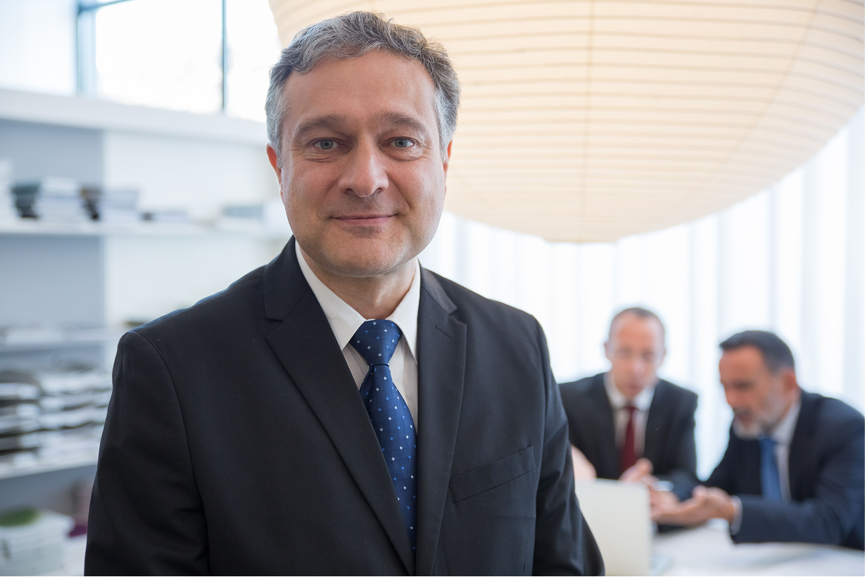 Senior living executive smiling in a boardroom