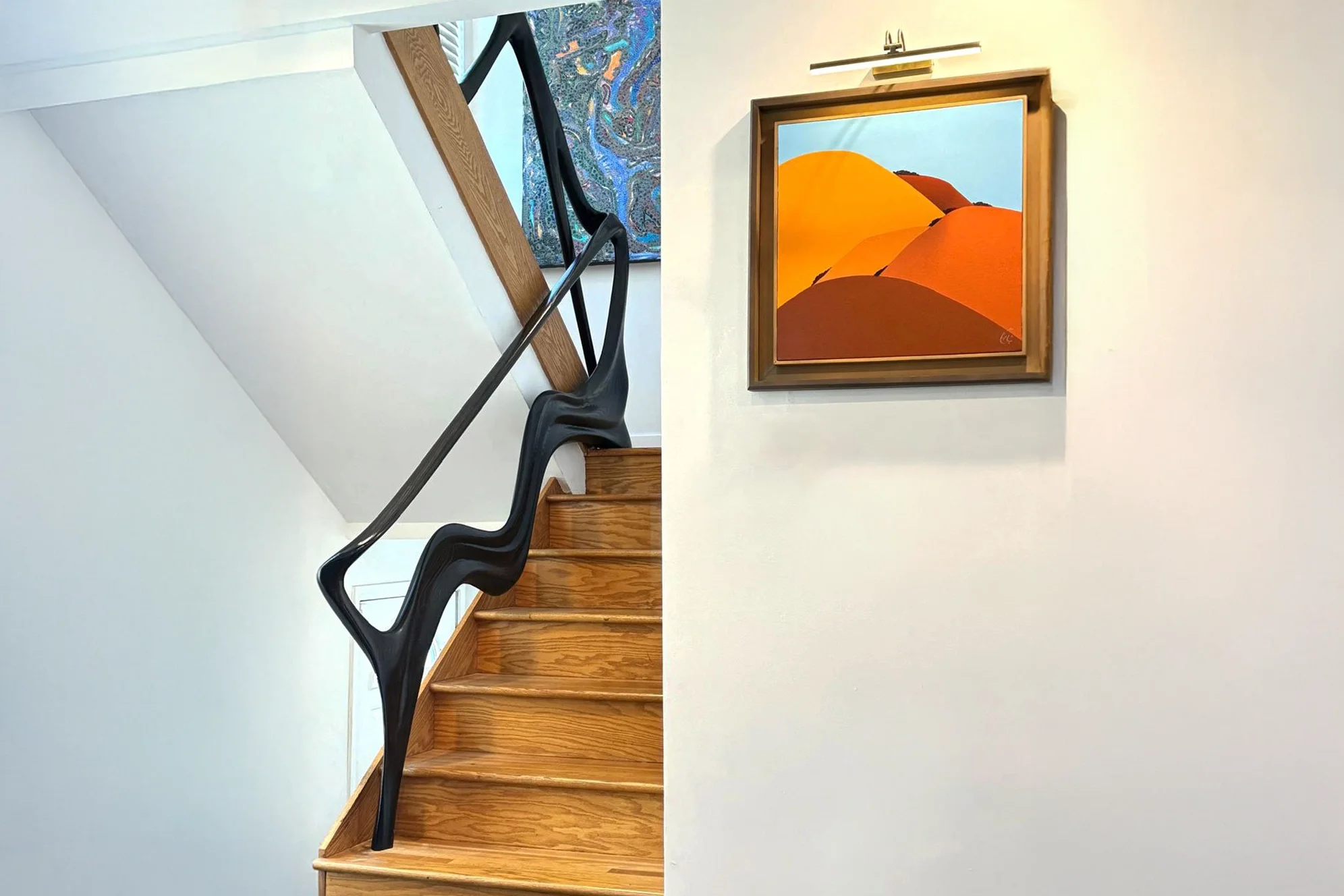 Sculptural solid wood staircase handrail handcrafted in Los Angeles by Amorph Studio