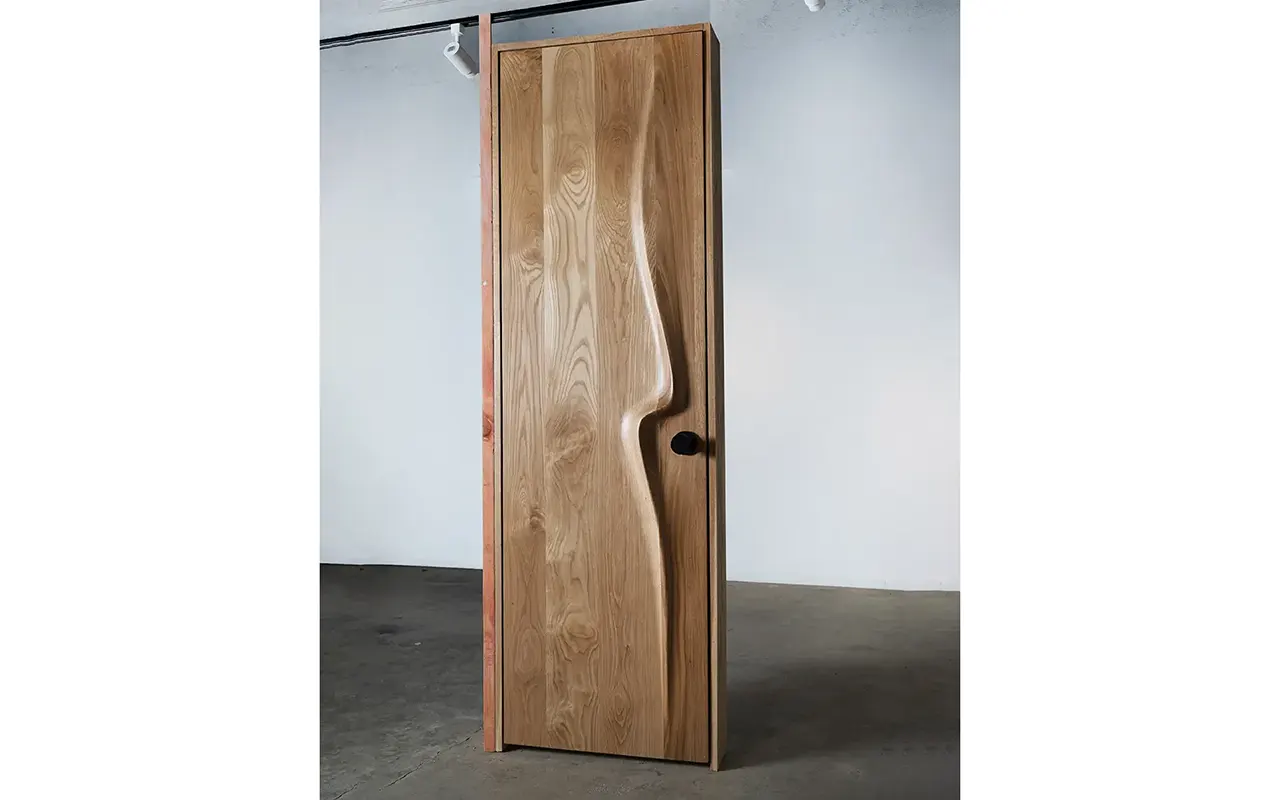 Sculptural solid wood interior door by Amorph Studio