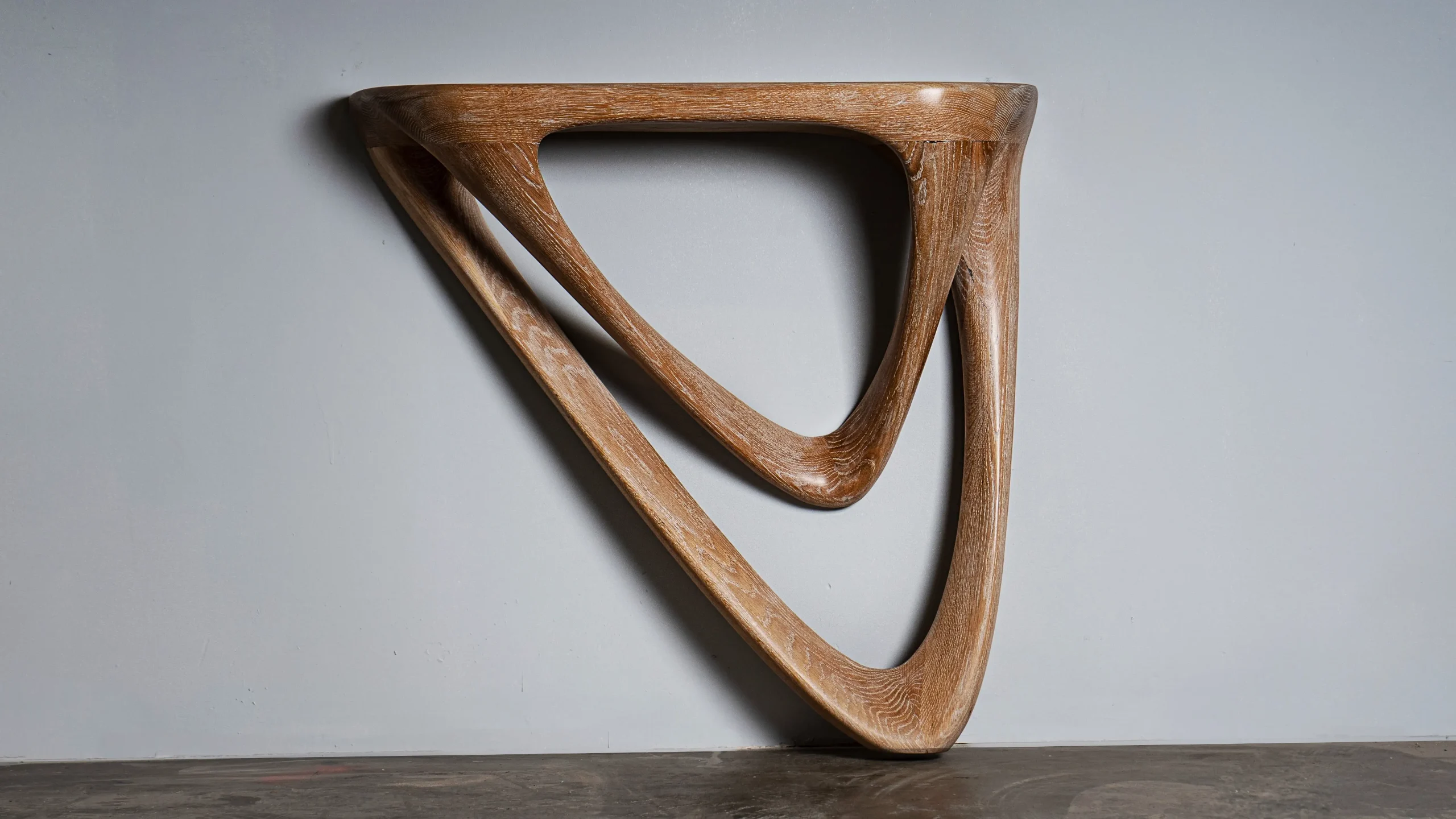 Sculptural solid wood wall mounted console Aras by Amorph Studio