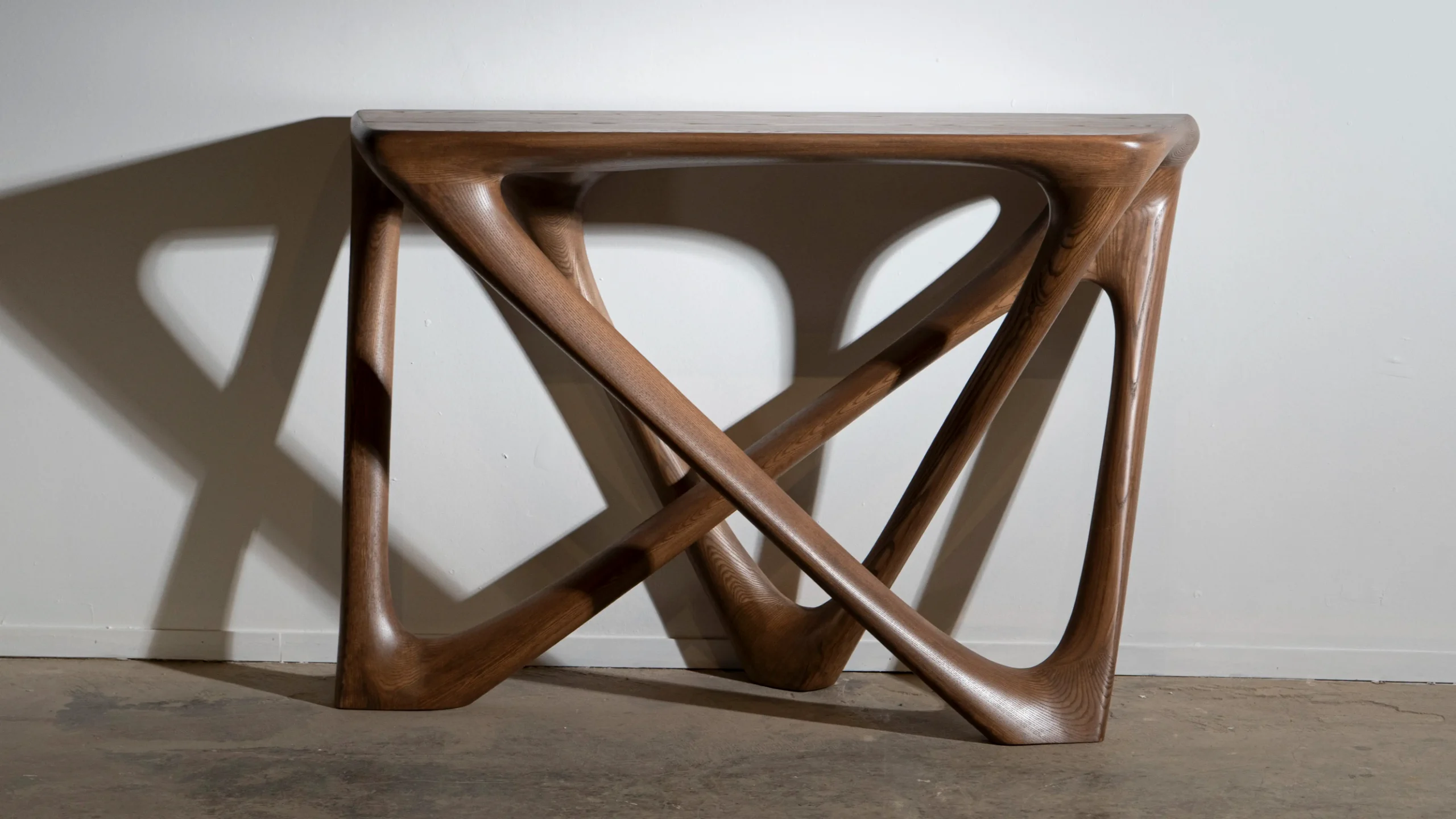 Sculptural solid wood console table Nava by Amorph Studio