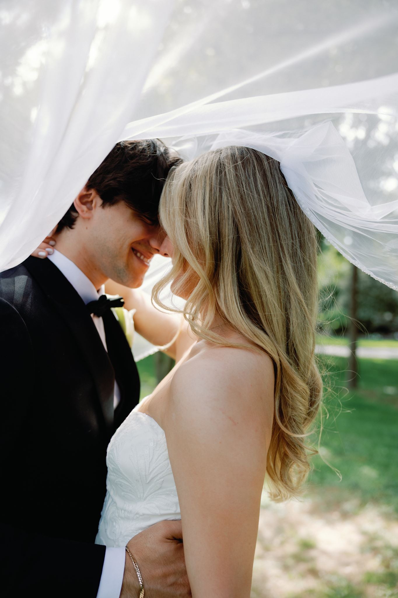 Caitlin and Greg kiss under the veil