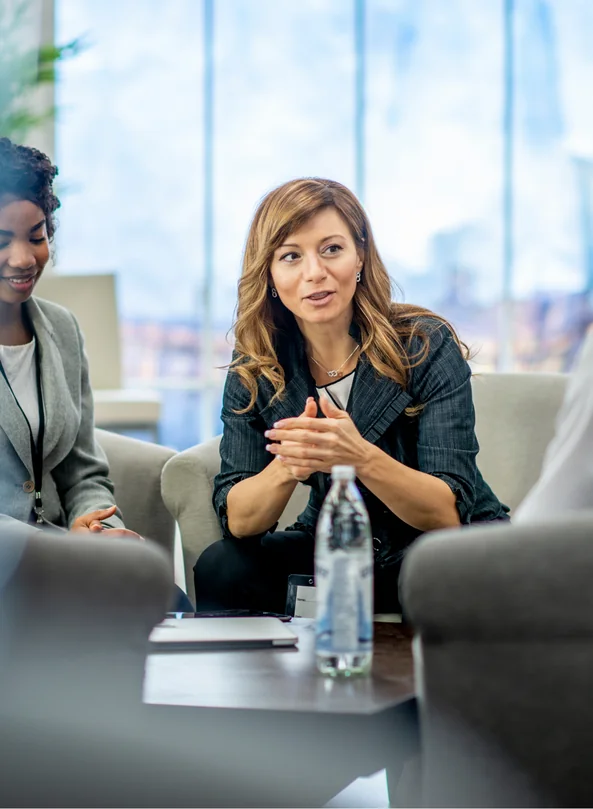 Colleagues in conversation around a meeting table