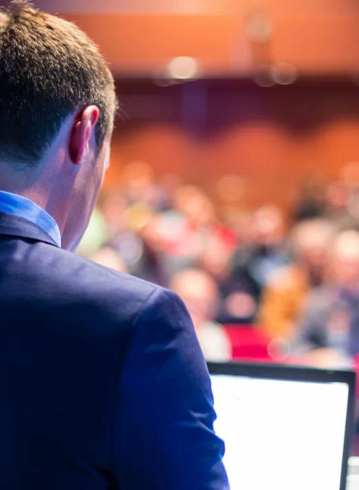 A speaker addressing a conference audience