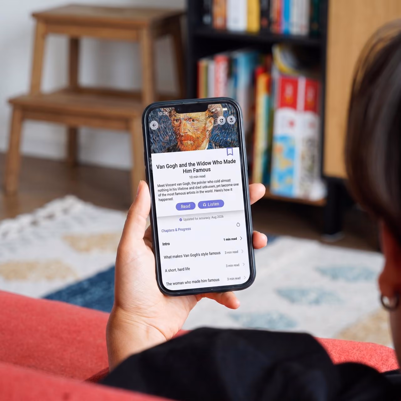 Person on a sofa holding a phone with the Nerdish article "Van Gogh and the Widow Who Made Him Famous"