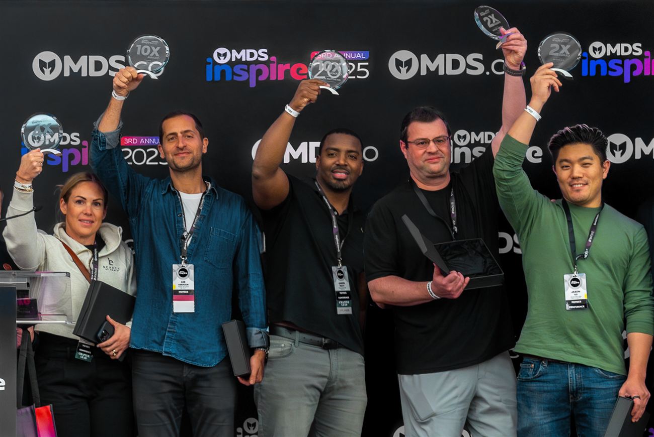 Founders holding MDS 10X awards on stage at MDS Inspire