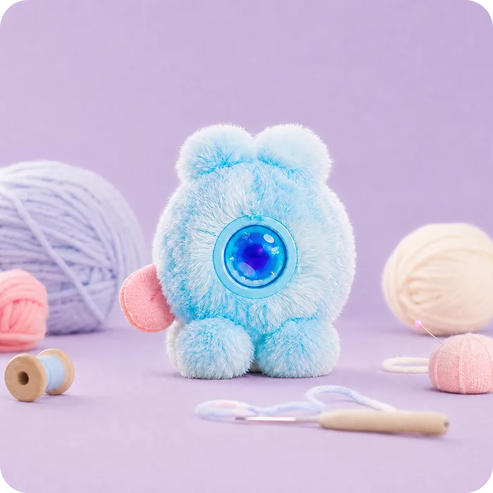 A blue Mumuland companion with pastel yarn