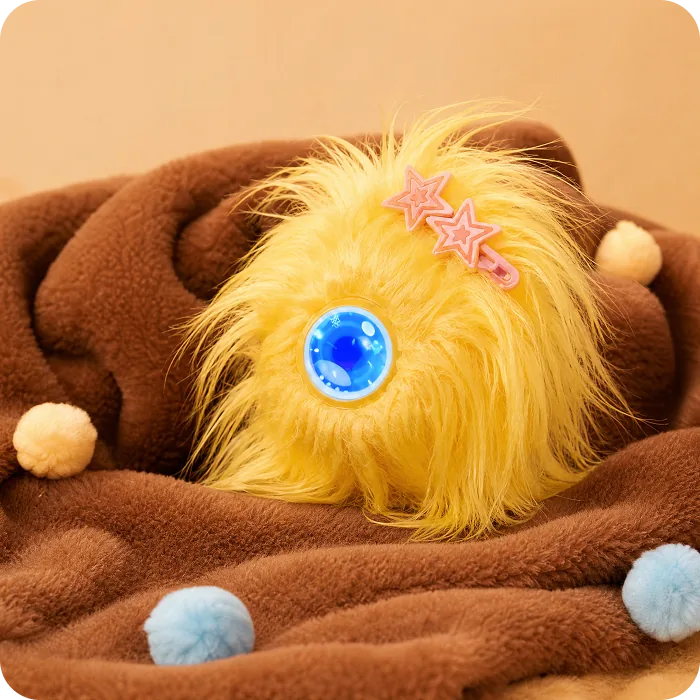 A yellow Mumuland companion on a brown blanket