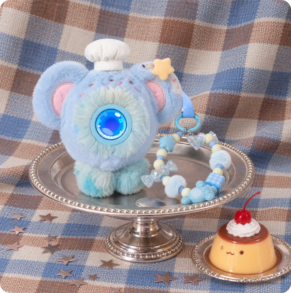 A blue Mumuland companion on a silver cake stand