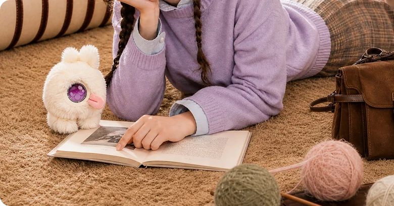 A child reading with a white Mumuland companion