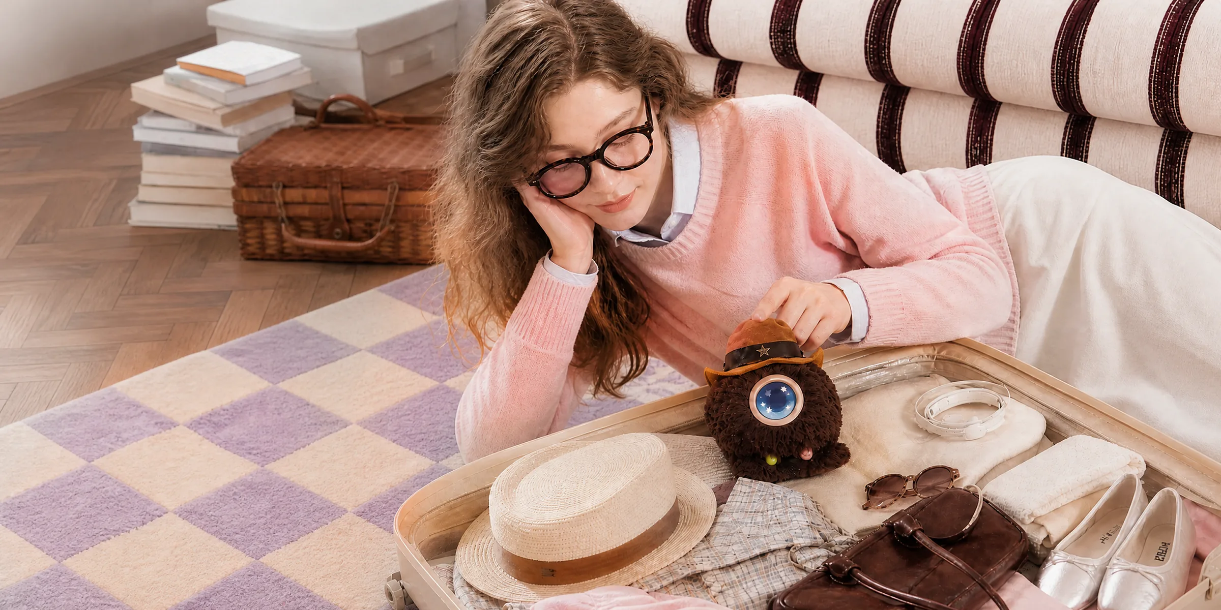 A girl lying on a checked rug with a yellow Mumuland companion