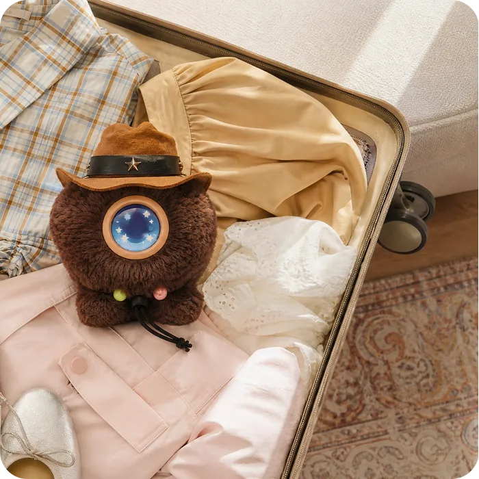 A Mumuland companion tucked inside an open suitcase
