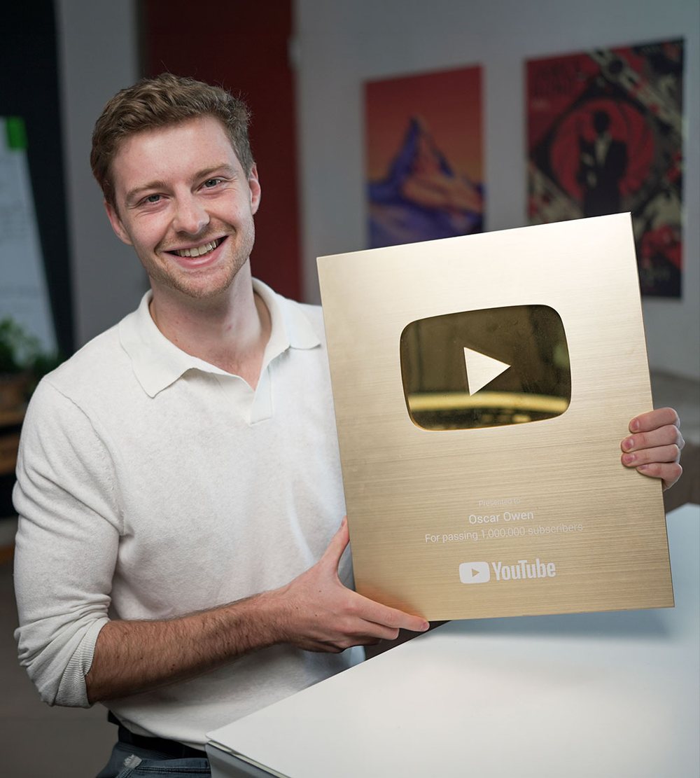 Oscar holding his YouTube Gold Play Button for passing one million subscribers
