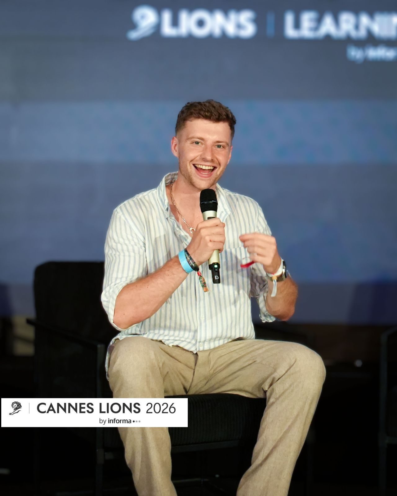 Oscar Owen speaking on stage at Cannes Lions