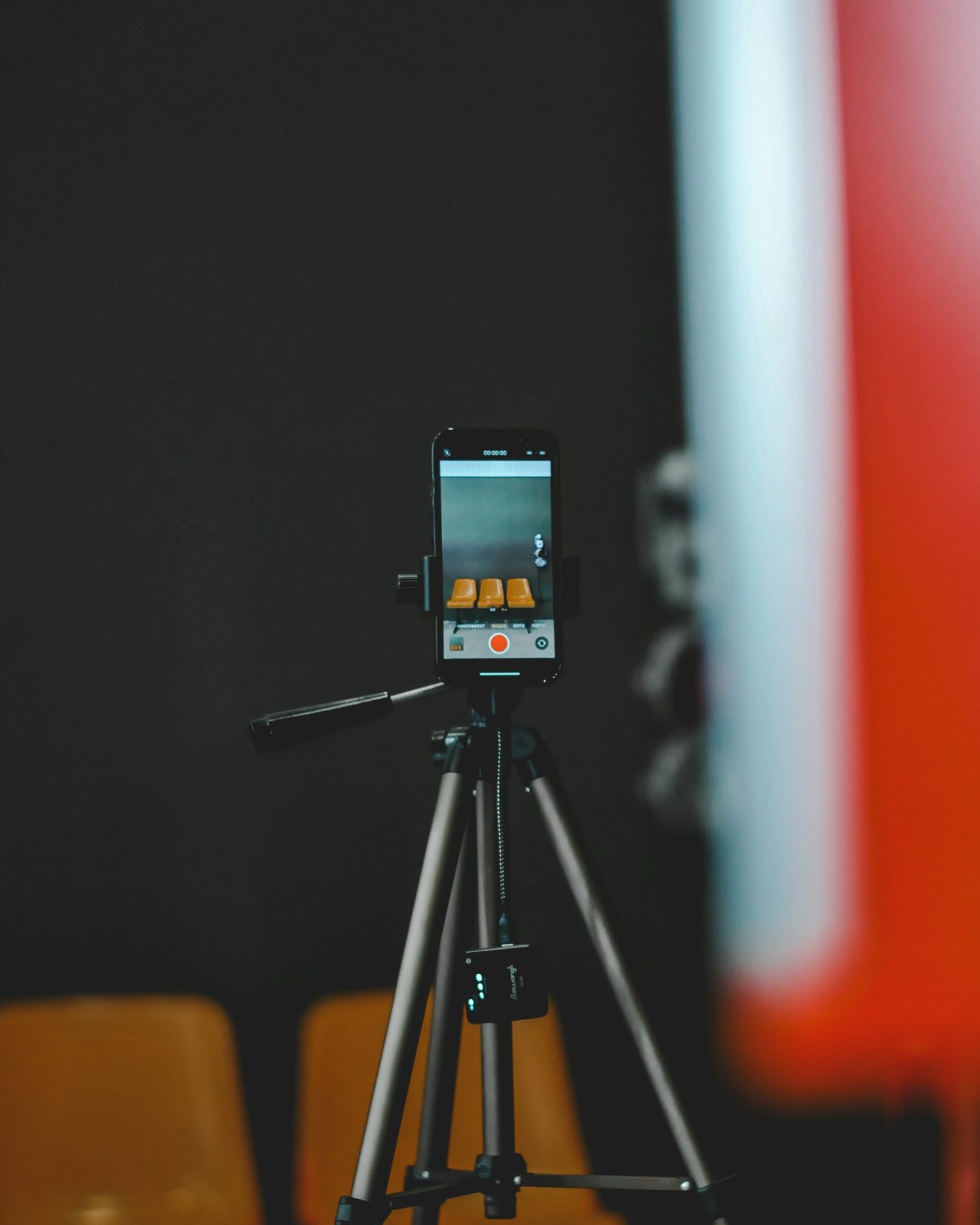 A smartphone mounted on a tripod ready to film vertical video