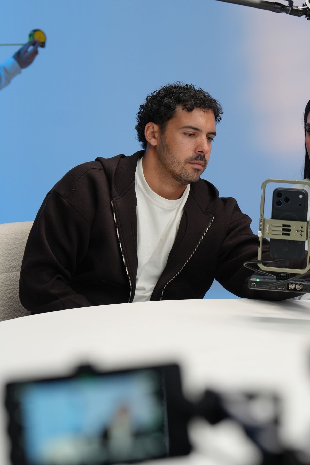 A cast member filming a skincare segment at the round table