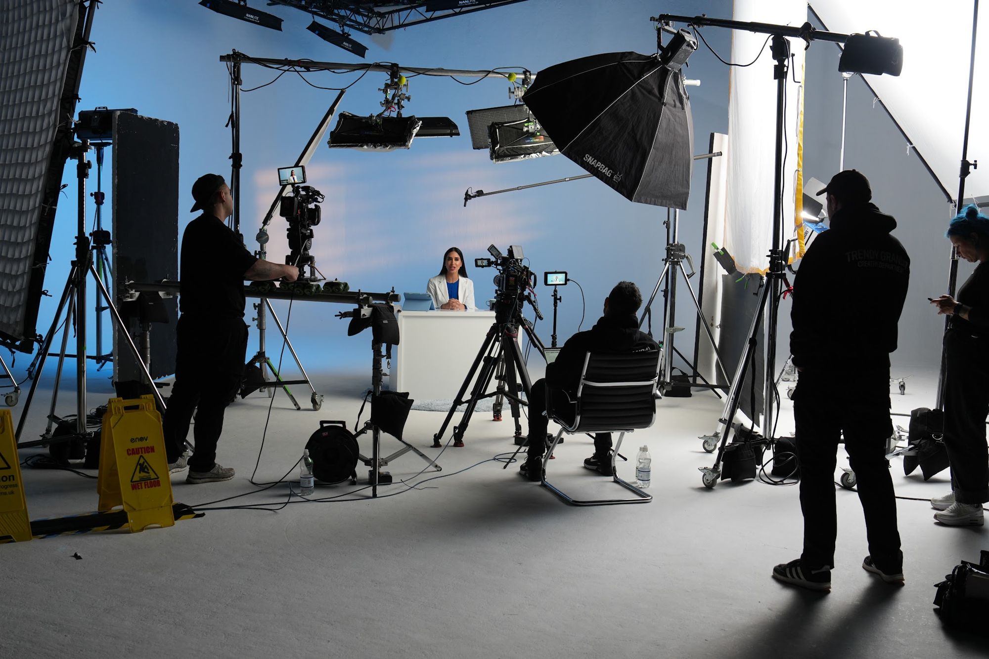 Wide view of the studio with crew, lighting and multiple camera rigs