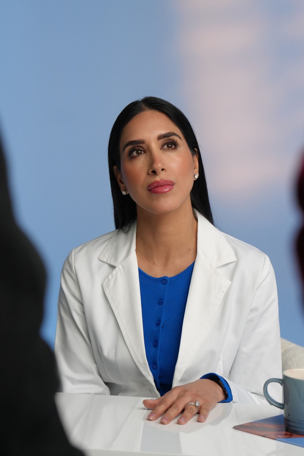 Dr Raj at the desk between takes