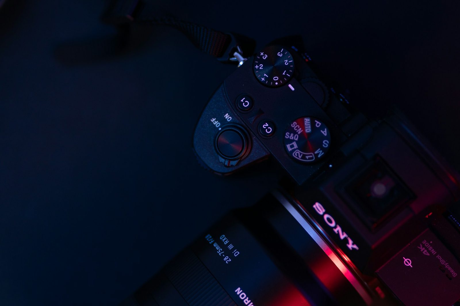 Top down view of Sony Alpha dials in blue and red light