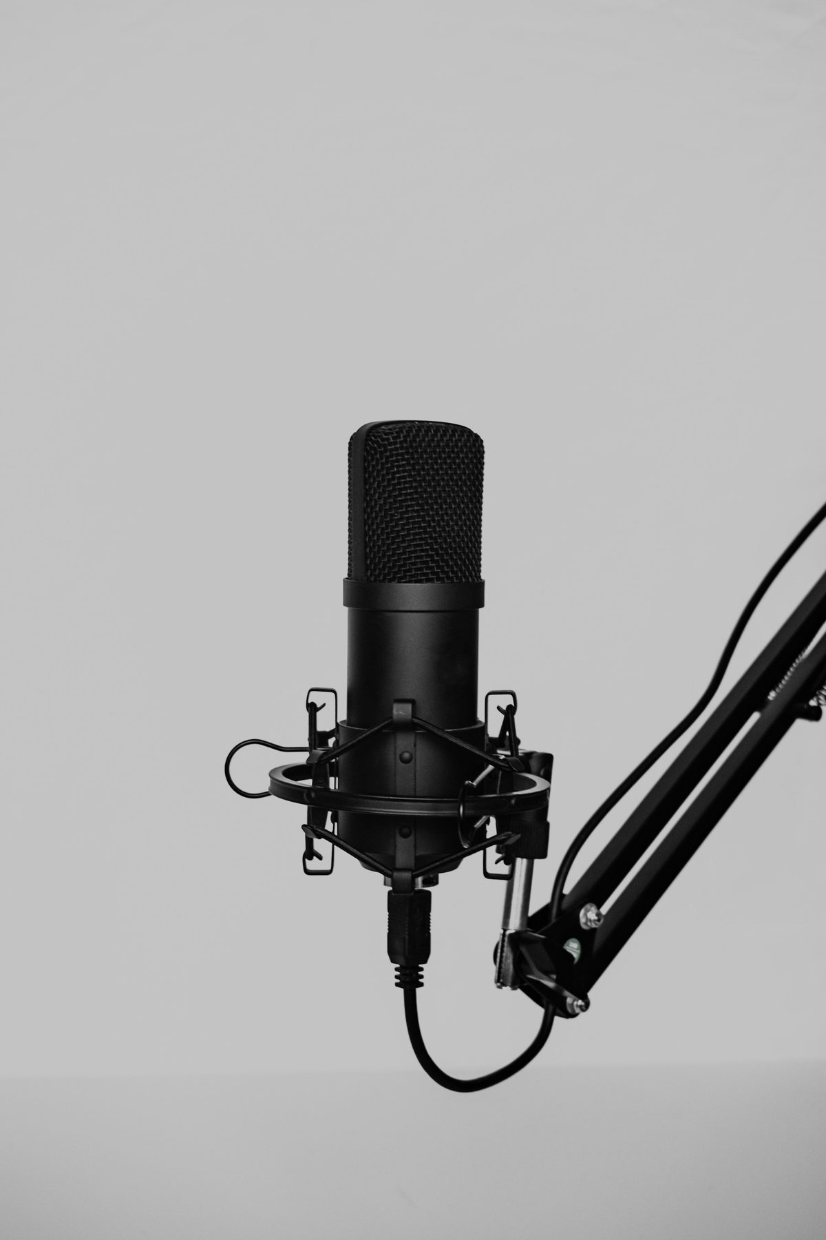 Studio condenser microphone on a boom arm ready to record a voiceover