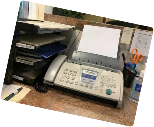 Fax machine on a cluttered desk
