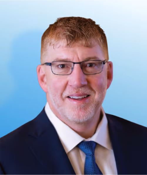 Professional headshot of a smiling man in glasses and navy suit