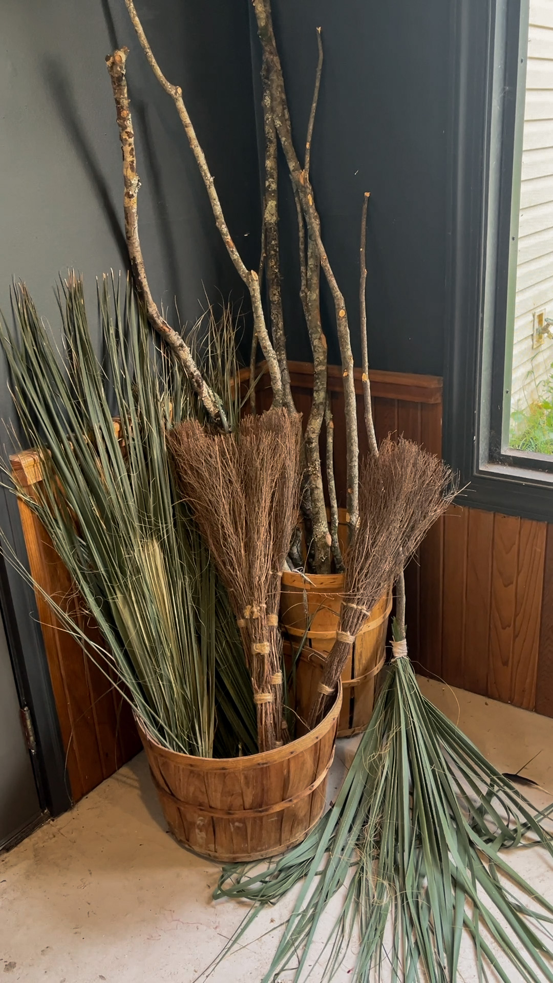 Branches, dried grasses and broom-making materials gathered in a wooden container