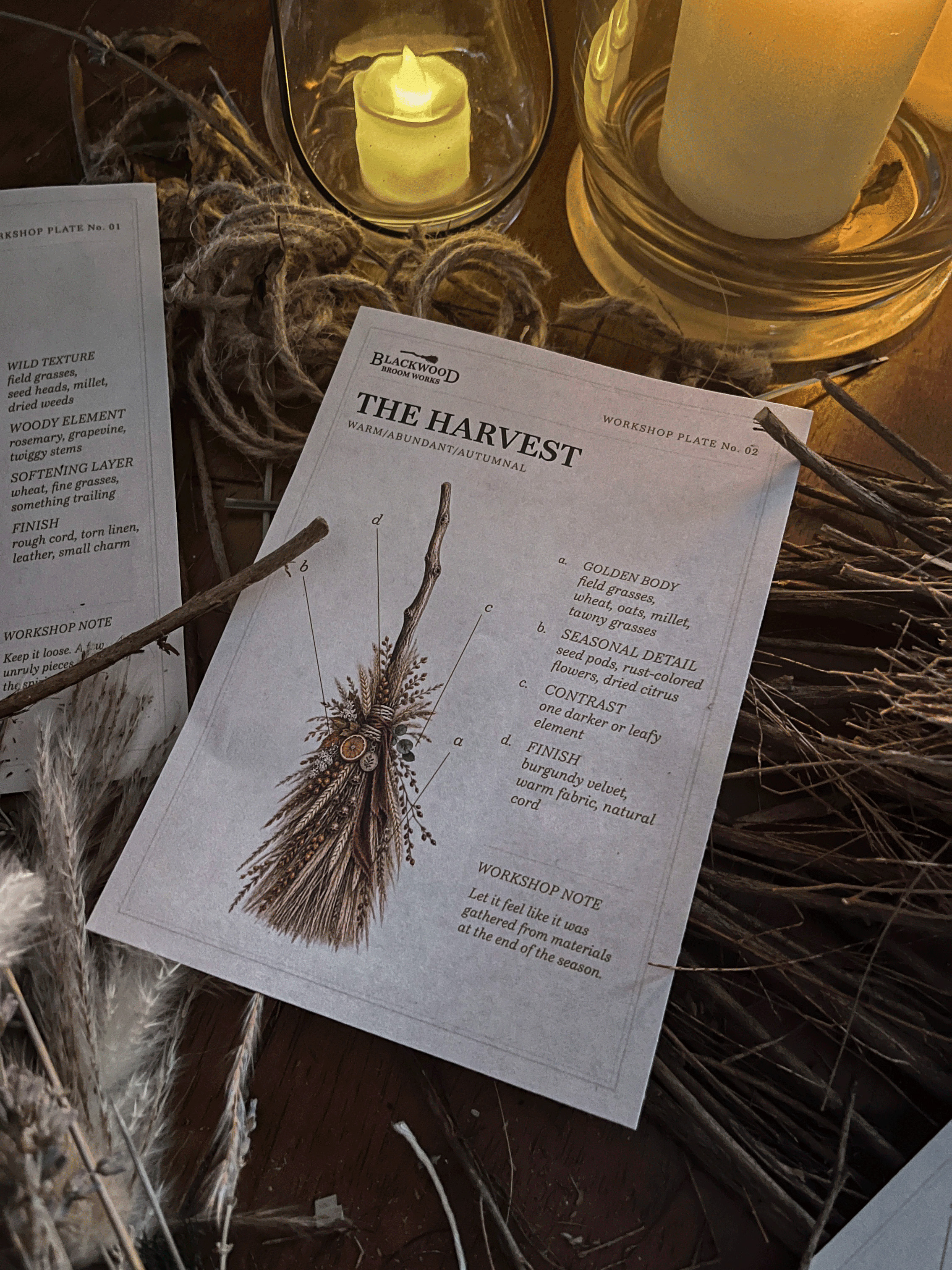 Broom-making inspiration card displayed among dried grasses and workshop materials