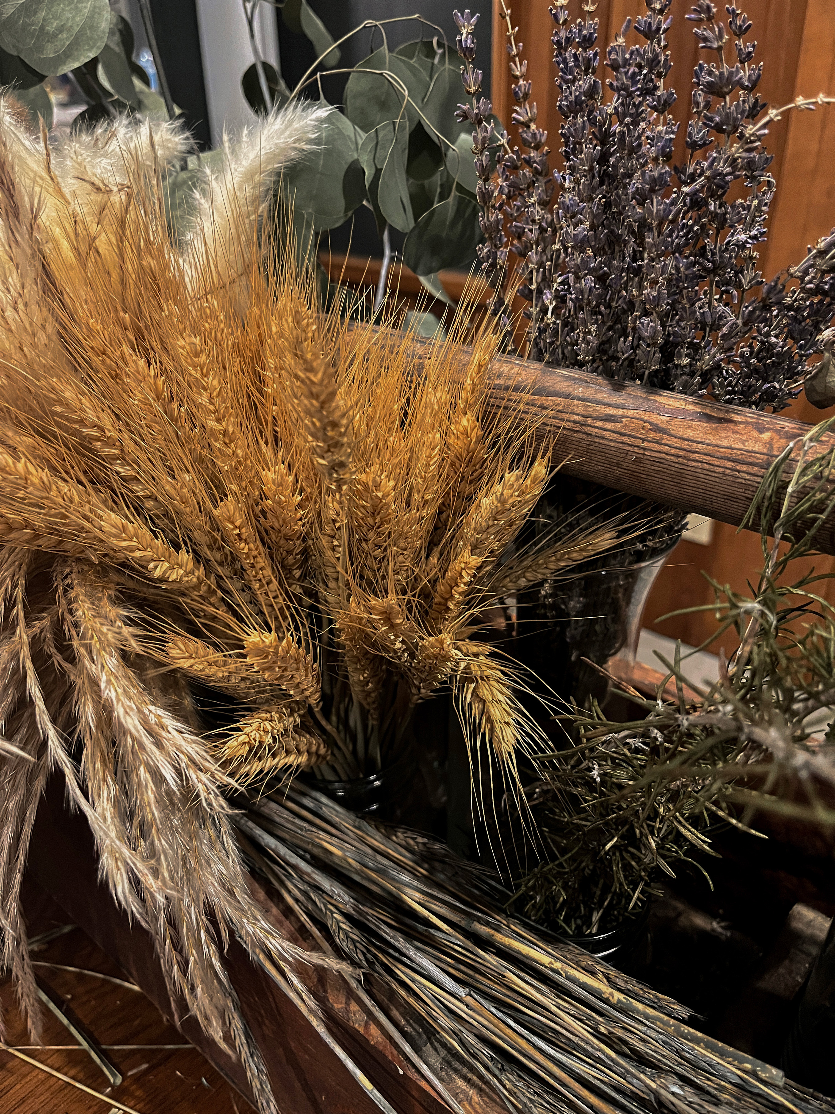 Bundles of dried grasses and natural materials arranged on the Broom Bar