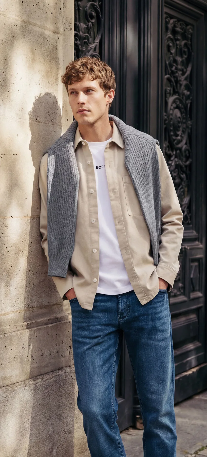 Man in a linen overshirt against a stone wall