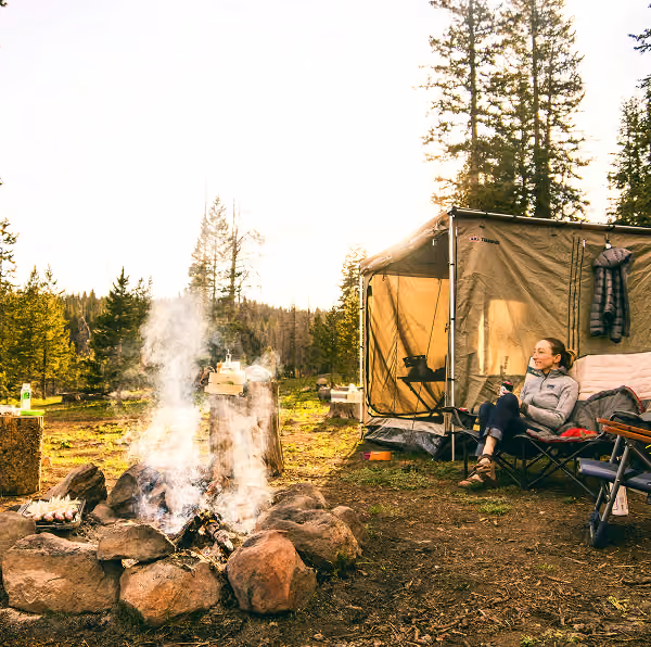 a person unwinds at a camp site
