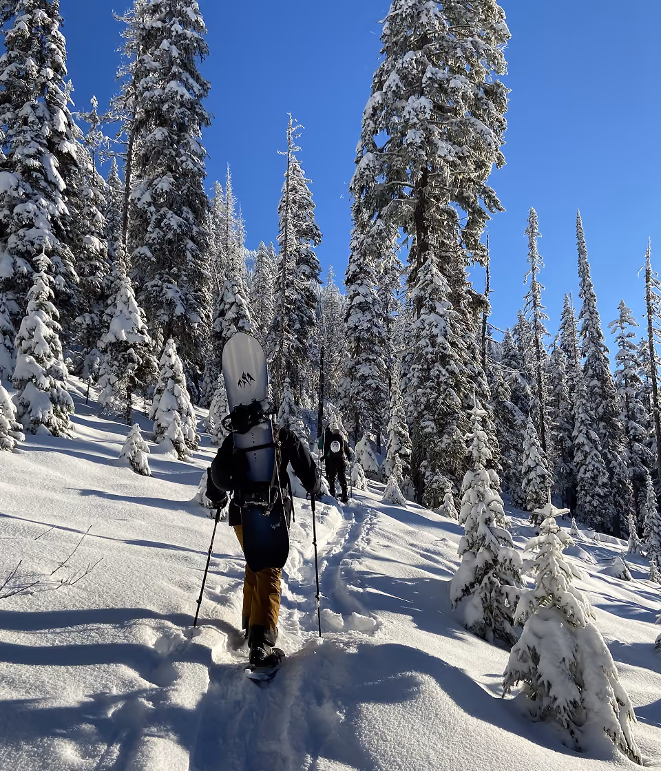 A person hikes through the snow