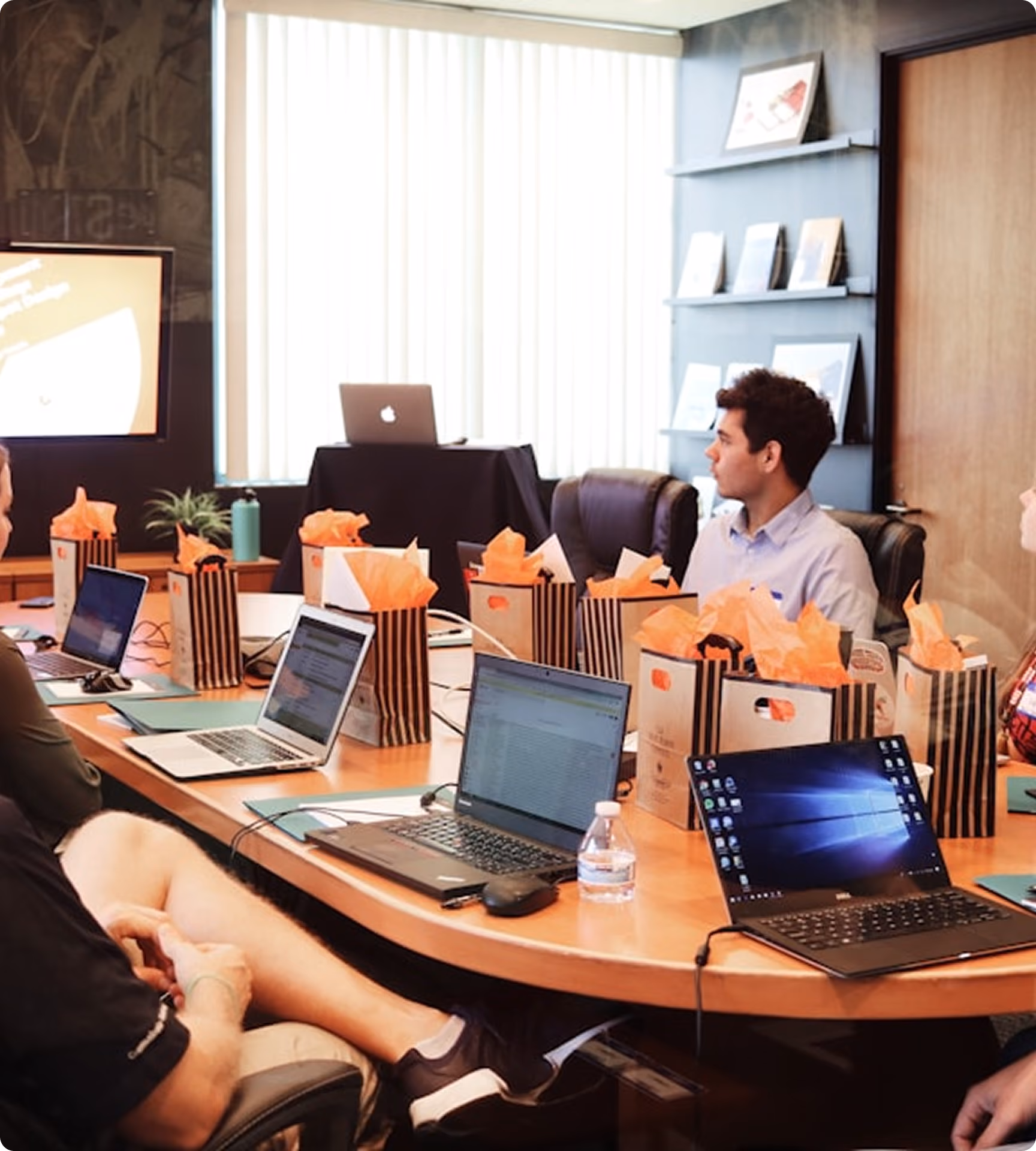 Business team collaborating around laptops in an office