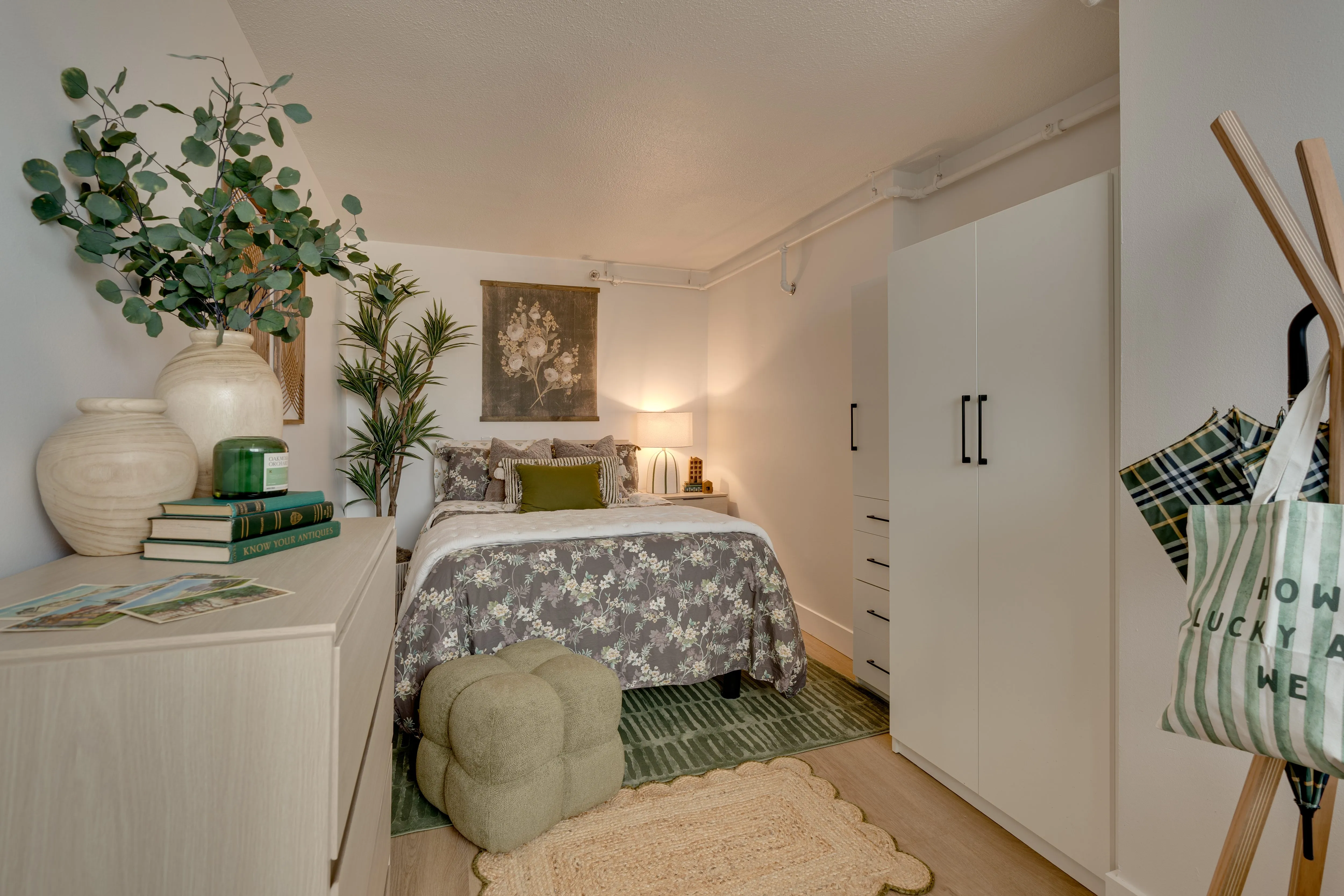 Furnished Buckner bedroom with full bed, dresser and white wardrobe