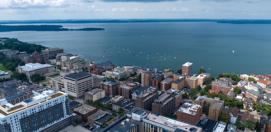 Aerial view of Madison at sunset with the lakeshore and the isthmus near the UW-Madison campus